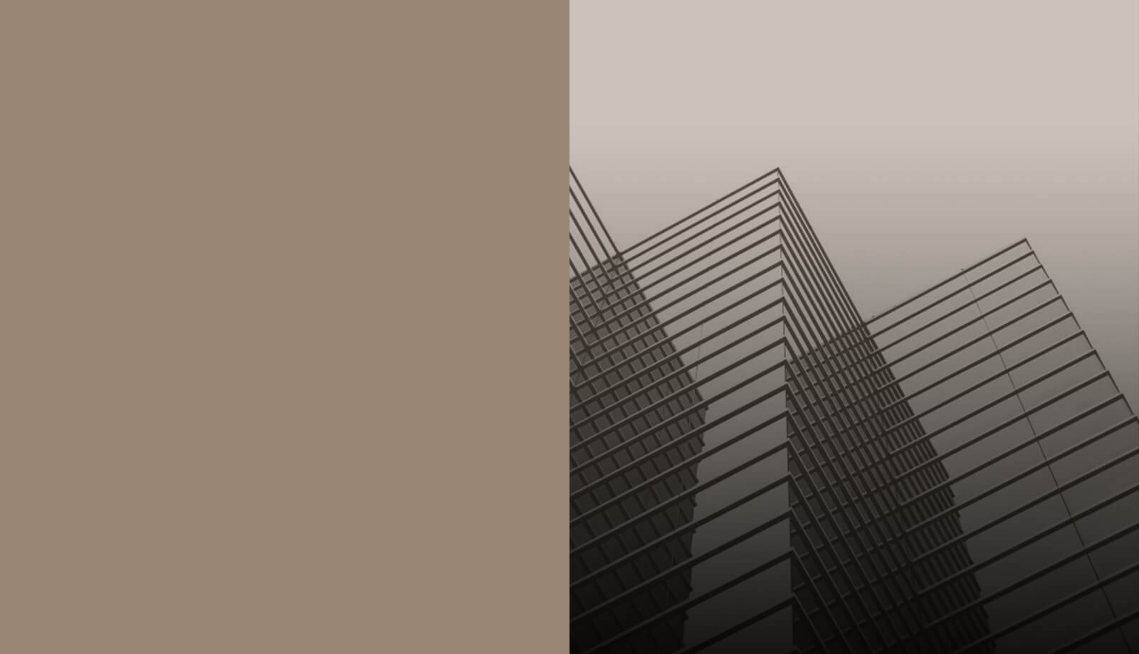 Glass office towers photographed from street level against a pale sky, beside a plain taupe field.